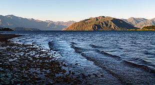 mountain beside body of water, lake wanaka, nz