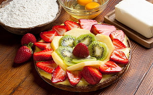 red strawberry fruits salad on round brown plate