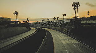 landscape photo of roads with bridge during sunset
